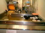 After you finish your meal, you put all your dirty bowls into this automated washing system, where they float like little ducks before being cleaned on the conveyor belt.